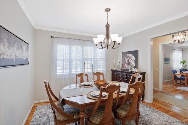 dining room with crown molding, an inviting chandelier, and a healthy amount of sunlight