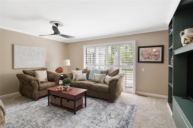 carpeted living room with crown molding, baseboards, ceiling fan, and visible vents
