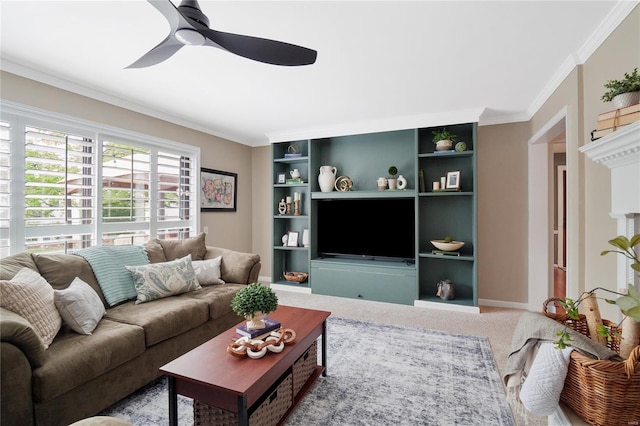 carpeted living room with a ceiling fan, baseboards, and ornamental molding