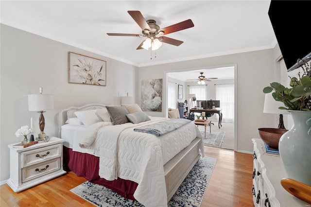 bedroom featuring crown molding, baseboards, a ceiling fan, and light wood-type flooring