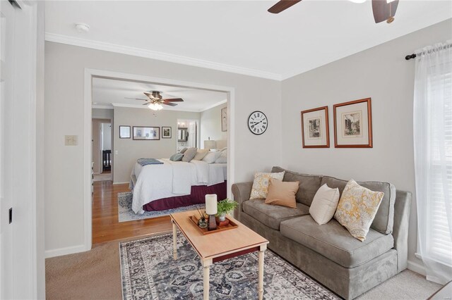 bedroom with crown molding, a ceiling fan, baseboards, and wood finished floors