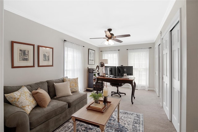 office with crown molding, ceiling fan, light colored carpet, and baseboards