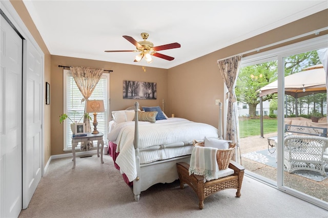 bedroom with carpet flooring, a ceiling fan, multiple windows, and access to exterior