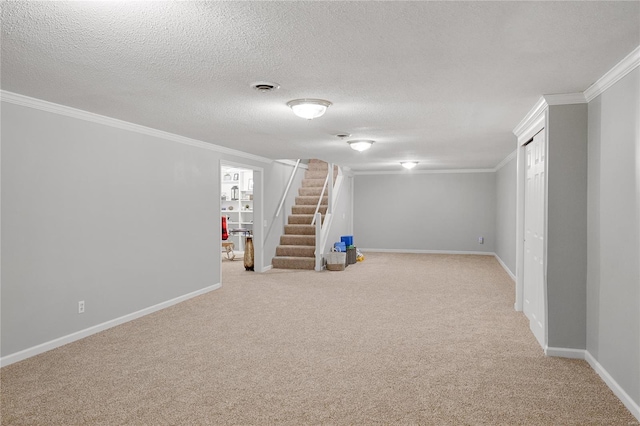 finished below grade area with carpet flooring, baseboards, ornamental molding, and stairway