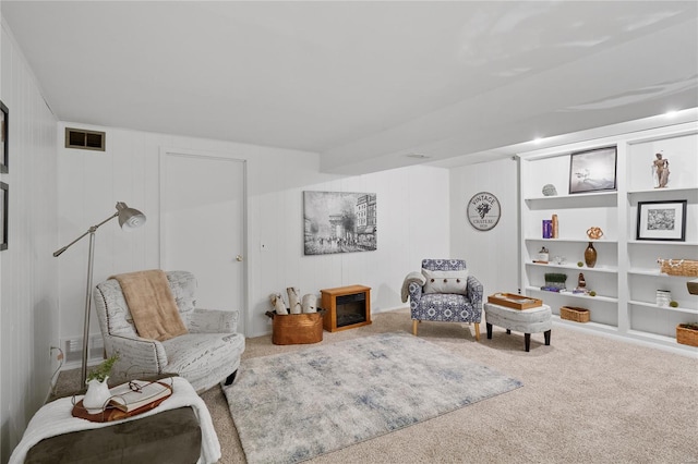 living area with carpet flooring, visible vents, and built in features