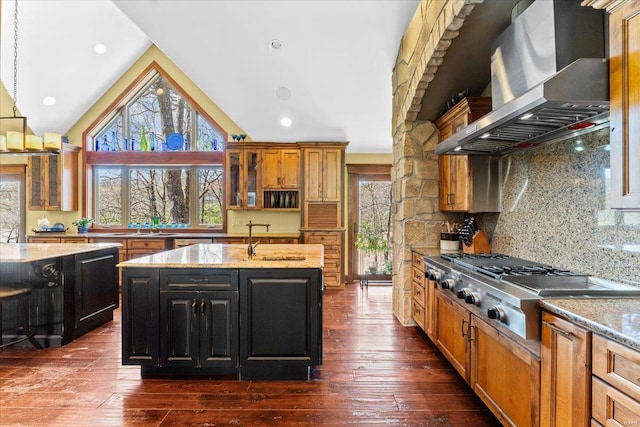 kitchen with wall chimney exhaust hood, stainless steel gas cooktop, lofted ceiling, and a wealth of natural light