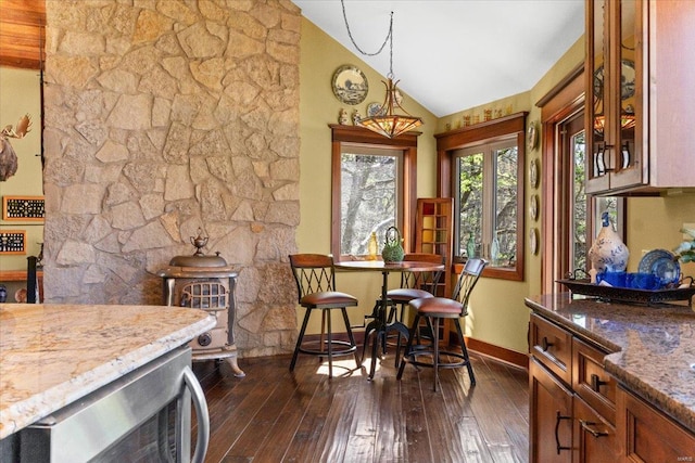 dining area featuring baseboards, vaulted ceiling, and dark wood-style flooring