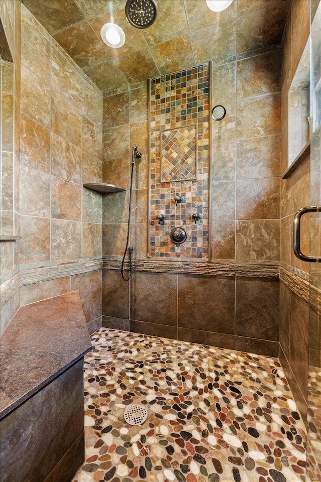 full bath with a tile shower