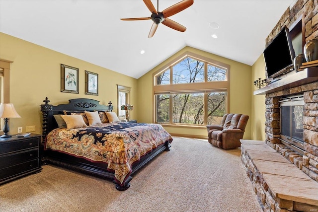 bedroom with carpet floors, a stone fireplace, ceiling fan, recessed lighting, and vaulted ceiling
