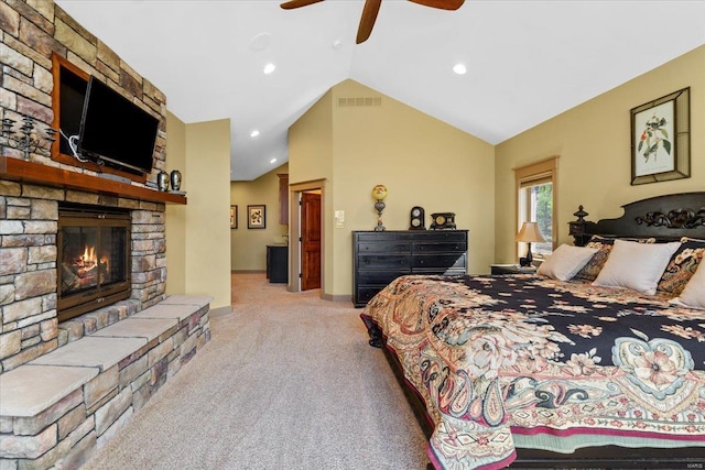 carpeted bedroom featuring a fireplace, vaulted ceiling, recessed lighting, and visible vents