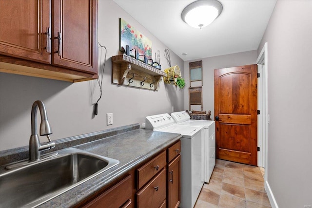 clothes washing area featuring cabinet space, independent washer and dryer, a sink, baseboards, and stone finish flooring