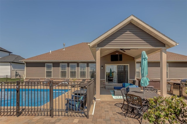 view of swimming pool with fence, a patio area, a fenced in pool, and ceiling fan