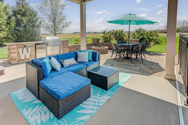 view of patio / terrace featuring grilling area, outdoor dining space, an outdoor living space with a fire pit, and area for grilling