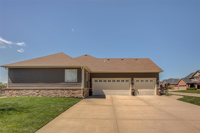 view of front of property with roof with shingles, driveway, stone siding, an attached garage, and a front yard