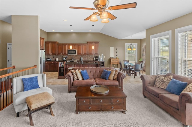living room featuring vaulted ceiling, light carpet, and ceiling fan