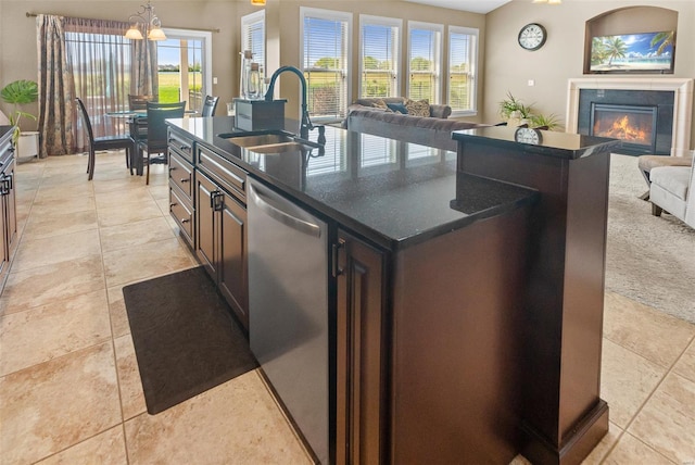 kitchen with open floor plan, dishwasher, a sink, and an island with sink
