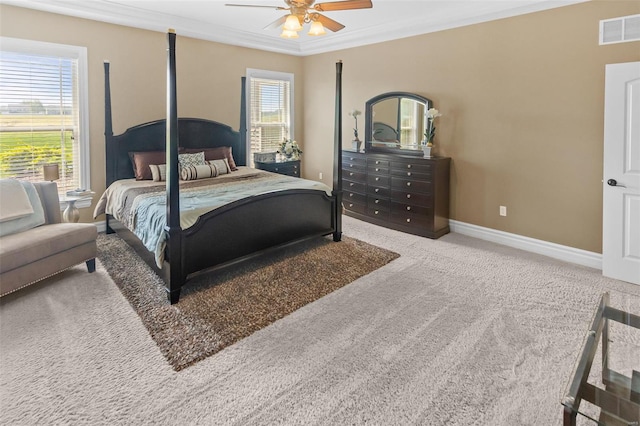 carpeted bedroom featuring baseboards, ornamental molding, multiple windows, and visible vents
