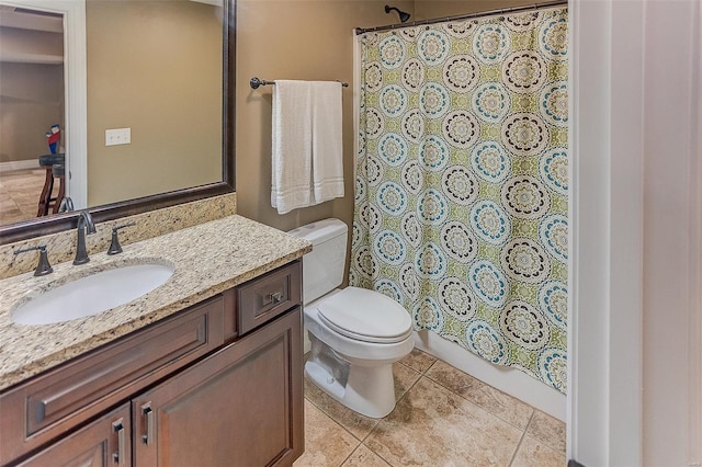 bathroom with toilet, a shower with curtain, vanity, and tile patterned floors