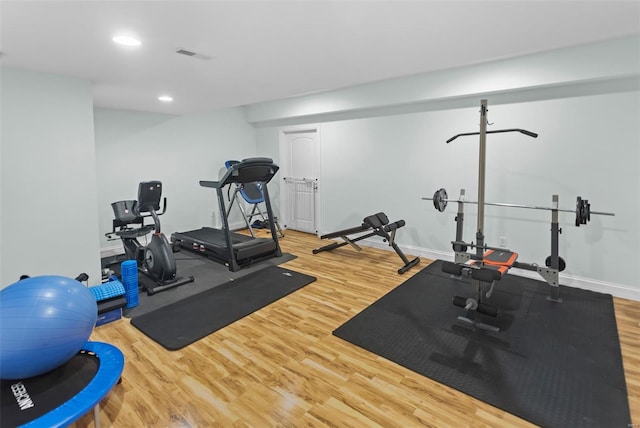 workout room with baseboards, wood finished floors, visible vents, and recessed lighting