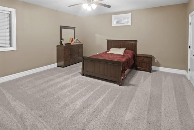 carpeted bedroom featuring a ceiling fan and baseboards