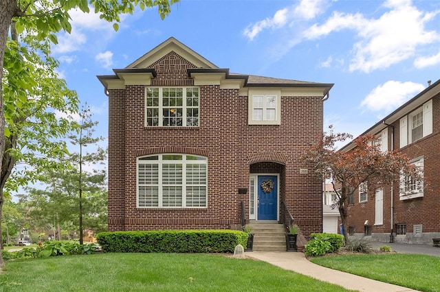 traditional-style home featuring brick siding and a front lawn