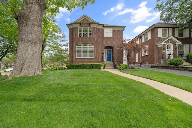 traditional-style home featuring a front lawn and brick siding