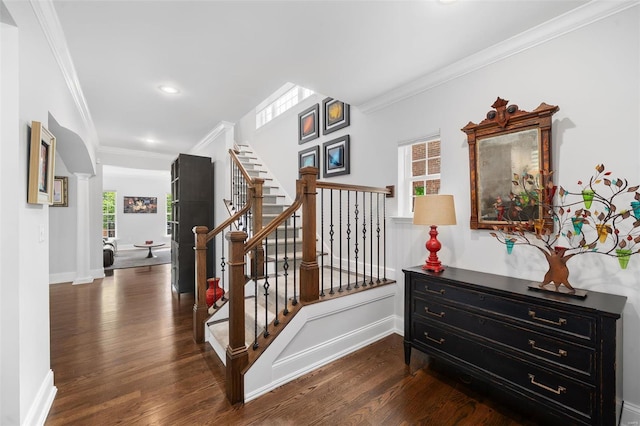 staircase featuring a healthy amount of sunlight, ornamental molding, recessed lighting, and wood finished floors