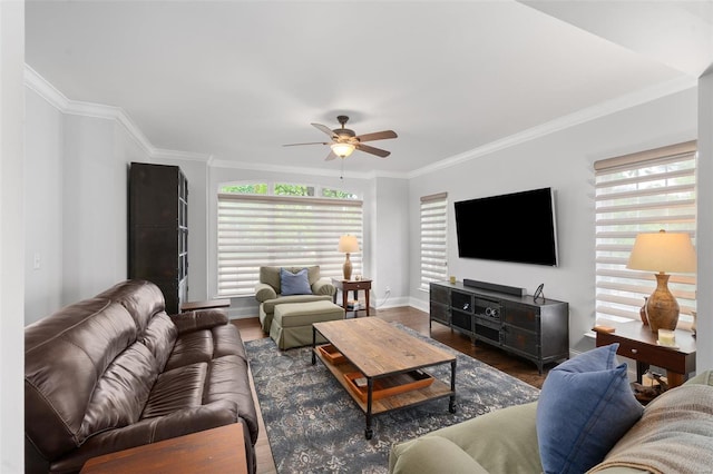 living area with ornamental molding, ceiling fan, wood finished floors, and a wealth of natural light