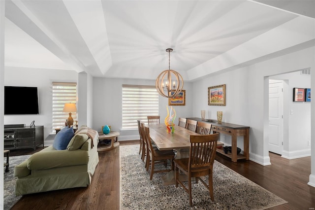 dining room featuring visible vents, wood finished floors, baseboards, a tray ceiling, and a notable chandelier