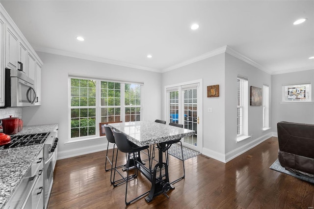 dining space featuring crown molding, recessed lighting, baseboards, and dark wood finished floors