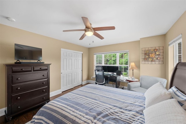 bedroom featuring a ceiling fan, baseboards, and dark wood-type flooring