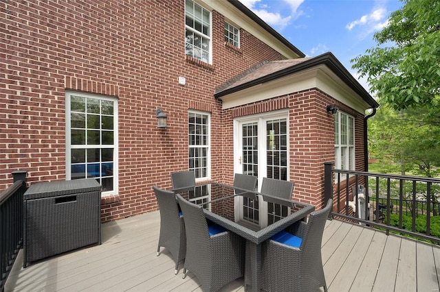 wooden terrace with outdoor dining area