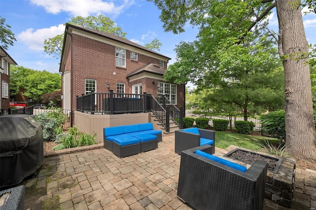 view of patio with fence, an outdoor hangout area, area for grilling, a deck, and stairway