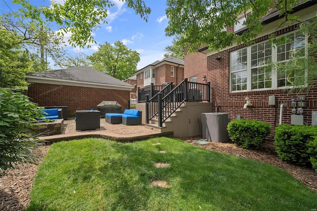 exterior space with a patio, a lawn, and brick siding