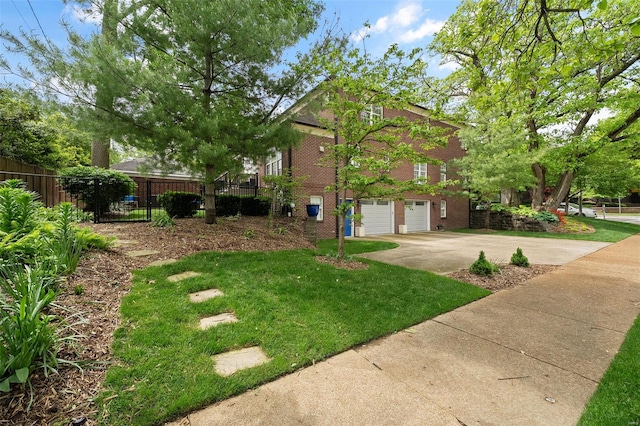 view of home's exterior with driveway, a lawn, a garage, brick siding, and fence