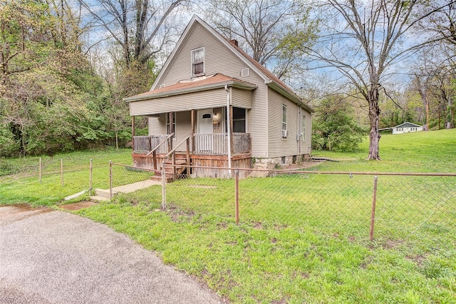 view of front of property featuring a porch, a front lawn, fence, and a chimney