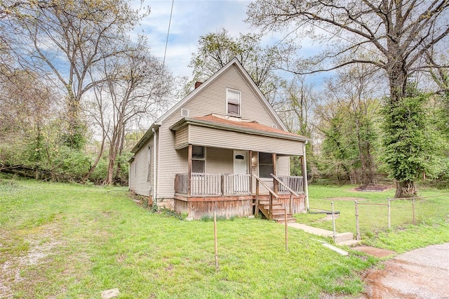 view of front facade featuring a porch, a front lawn, and a chimney