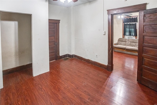 unfurnished bedroom with wood finished floors and baseboards