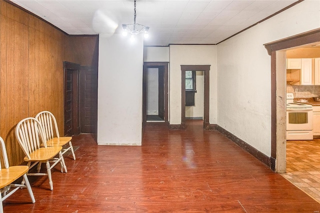 corridor with wooden walls and wood finished floors