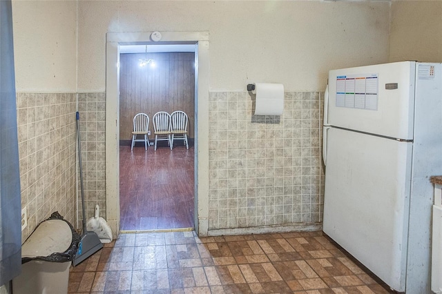 bathroom with tile walls and a wainscoted wall