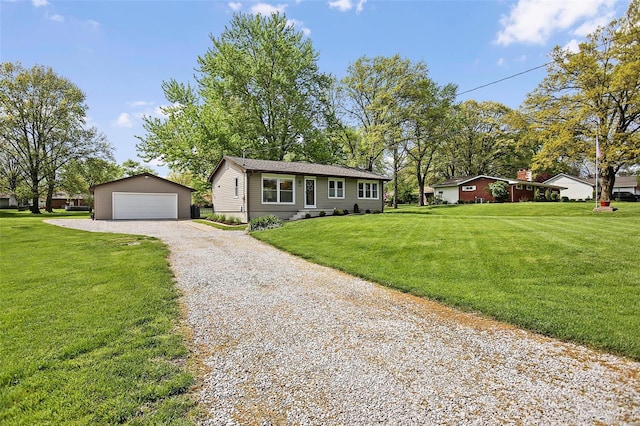 single story home featuring an outbuilding, a front lawn, and a garage