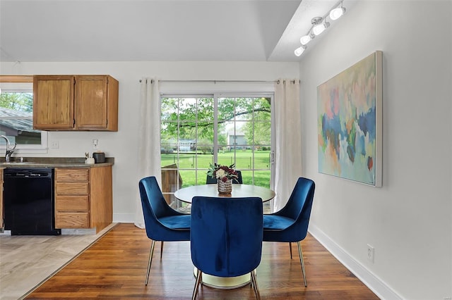 dining room featuring baseboards and light wood-style flooring