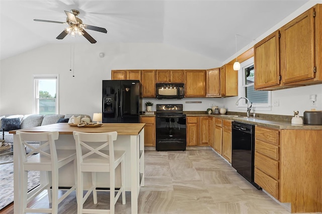kitchen with a ceiling fan, lofted ceiling, a sink, and black appliances