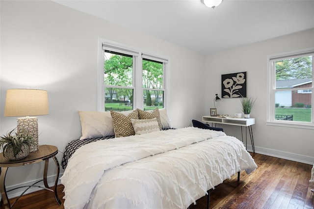 bedroom with baseboards and hardwood / wood-style flooring
