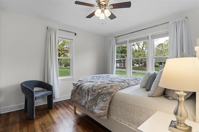 bedroom featuring baseboards, a ceiling fan, and hardwood / wood-style floors