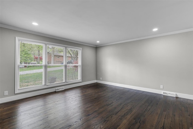 empty room featuring visible vents, baseboards, and ornamental molding