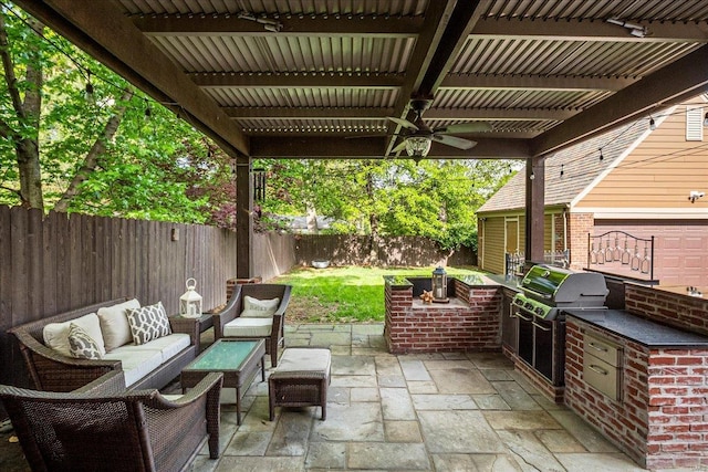 view of patio featuring a fenced backyard, ceiling fan, area for grilling, and outdoor lounge area