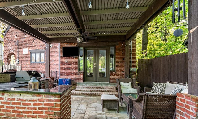 view of patio with a ceiling fan, fence, french doors, and area for grilling