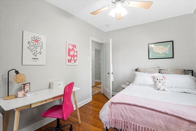 bedroom featuring baseboards, a ceiling fan, and wood finished floors