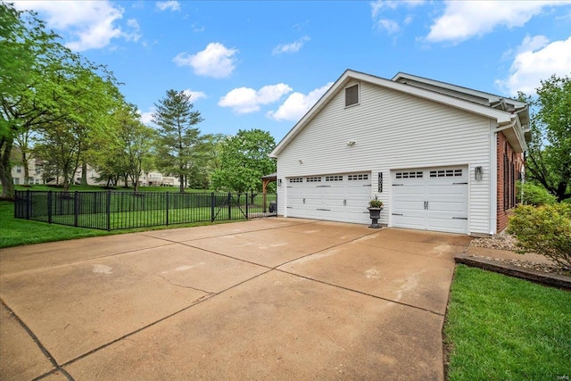 view of side of home with fence and a yard